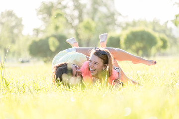 Two girl laughing on grass