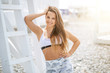 © alfa27 - Woman with perfect fit body showing off beach body abs, weight loss diet care and training concept. Happy girl with slim waistline muscular body on sky background.