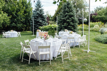 Wall Mural - Wedding. Banquet. Chairs and honeymooners table decorated with candles,