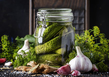 Homemade Marinated Or Pickled Cucumbers With Dill, Garlic And Spices In Big Glass Jar On Rustic Brown Table, Selective Focus