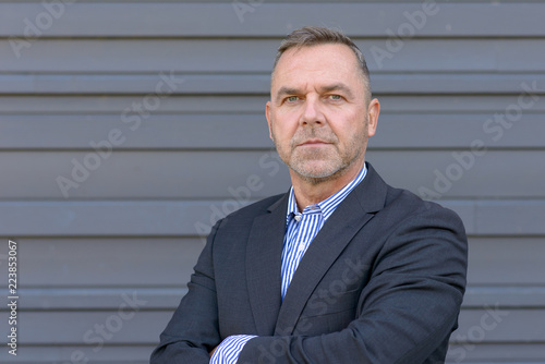 Photographie Confident middle age businessman over gray