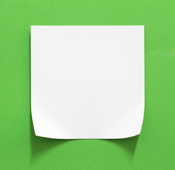 Torn white paper with green color as background