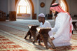 © FS-Stock - Muslim men praying with holy books in mosque
