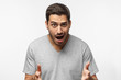 © Damir Khabirov - Crazy shocked young man in gray t-shirt with wide opened mouth and bugged eyes, shouting oh my god! Wow! Really?