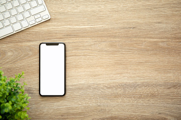 phone with isolated screen on wooden table with a keyboard