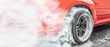 © toa555 - Drag racing car burns rubber off its tires in preparation for the race