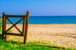 Sea shore – beautiful landscape view of the beach with golden sand, wooden gate, clear blue sky, Pescara, Italy