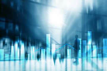 Financial graphs and charts on blurred business center background. Invesment and trading concept.