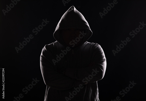 Fotomural studio portrait of a guy in a hood on a black background