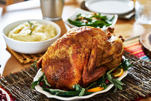 Thanksgiving Turkey On Dinner Table With Side Dishes