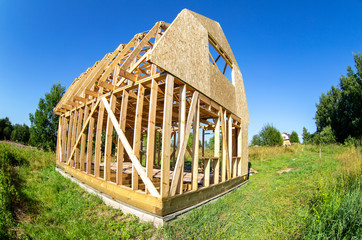 Canvas Print - Construction of a new wooden house at the village