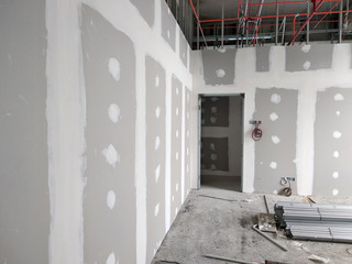 Wall Mural - Drywall installation work in progress by construction workers at the construction site. It is the easiest and cheapest way to do partition for an interior wall. 