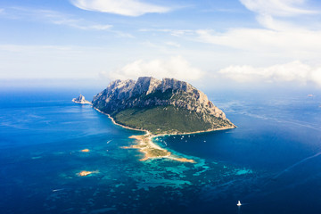 Wall Mural - Spectacular aerial view of Tavolara's island bathed by a clear and turquoise sea, Sardinia, Italy.