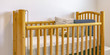 Wooden crib with mattress pillows and stuffed toy