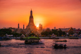 Fototapeta Koty - Sunset at Arun Temple or Wat Arun, locate at along the Chao Phraya river with a colorful sky in Bangkok, Thailand