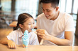© Tom Wang - Little girl with father  eating ice cream