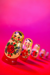 Wall Mural - RUSSIAN DOLLS ON RED PINK BACKGROUND