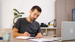 © DC Studio - Man writing on notebook at his desk. Putting thoughts on paper.