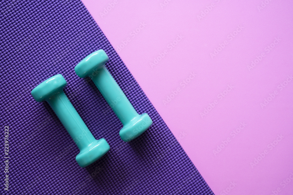 dumbbell and yoga mat on table, fitness healthy and sport concept - obrazy, fototapety, plakaty 