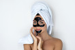 © blackday - Young and beautiful woman with black peel-off mask on her face