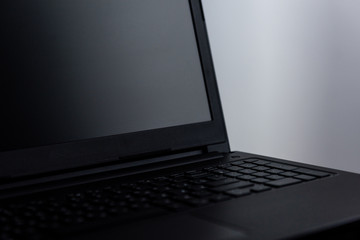laptop shot on reflective table on grey background