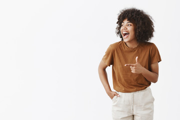 Wall Mural - cannot hide true happiness. portrait of joyful charming carefree african american woman with curly h