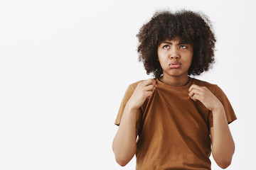 Wall Mural - girl hates hot summer days. portrait of displeased gloomy and bothered cute african american female 