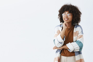 Wall Mural - artistic stylish and creative attractive dark-skinned female student in transparent glasses and tren