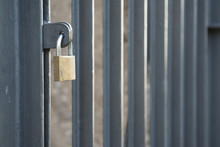 Closed Padlock On A Closed Gate With Vertical Bars