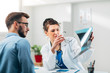 © Suteren Studio - Portrait of Woman Doctor at her Medical Office Looking at X-Ray with Patient