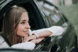 © Yakobchuk Olena - Side view happy woman with attractive smile looking away while locating in modern car. Glad lady thinking during rest in vehicle concept