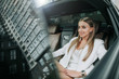 © Yakobchuk Olena - Portrait of beaming lady relaxing on cozy rear seat of modern car during journey at work