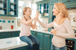 © zinkevych - Lets play. Beautiful kid sitting on the table and demonstrating her love to mother