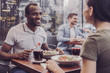 © zinkevych - Enjoy your meal. Cheerful male person keeping smile on his face and looking at his friend
