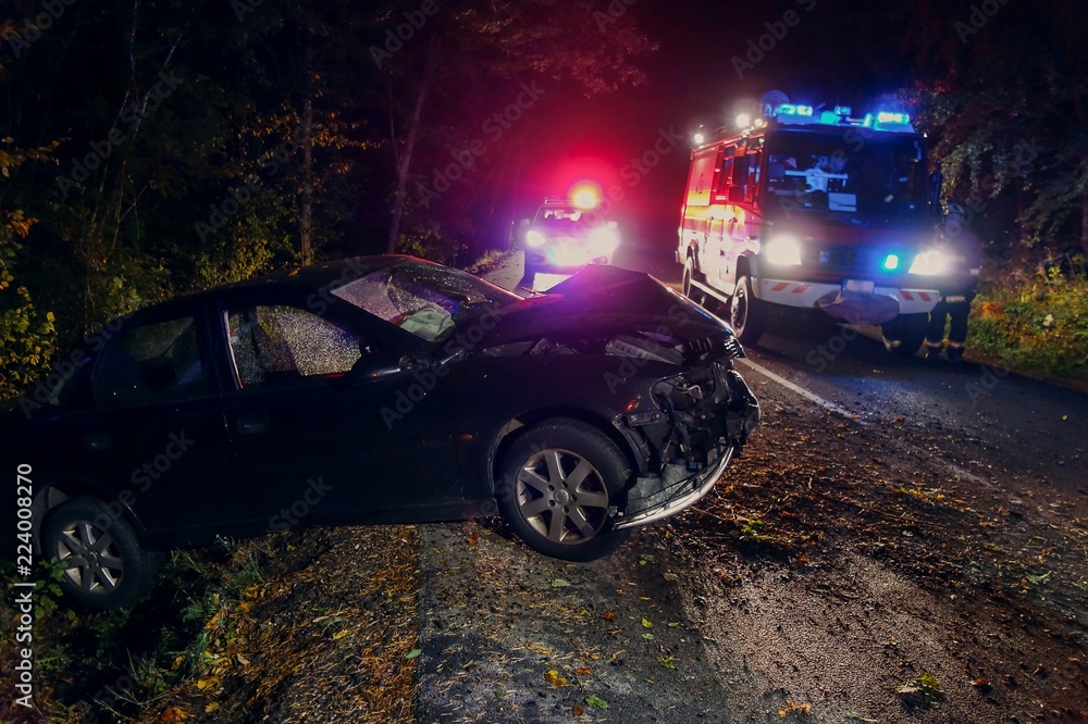 Real event. Car accident. The car crashed at night on a wet road . Car accident over raining day in autumn time. Rescuers help with car accident, ambulance, fire and police. - obrazy, fototapety, plakaty 