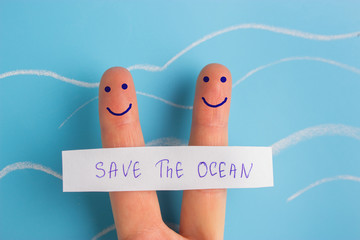 save the ocean concept. two fingers with sing save the ocean