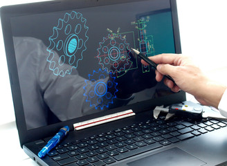 engineer working on computer at mechanical piece design cad blueprint