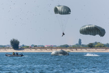 A Boat Preparing To Rescue The Fallen Parachutists At An Airshow