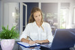 © sepy - Businesswoman working hard in the office