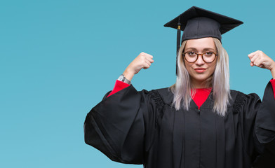 Sticker - Young blonde woman wearing graduate uniform over isolated background showing arms muscles smiling proud. Fitness concept.