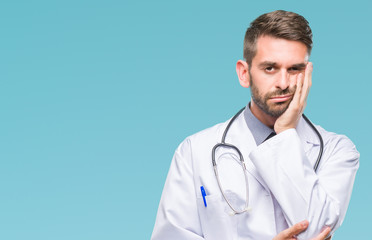 Sticker - Young handsome doctor man over isolated background thinking looking tired and bored with depression problems with crossed arms.