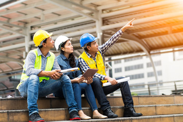 Male and female engineers asians of engineering team checking construction plan in the morning.