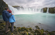 Couple at Goðafoss waterfall, Iceland