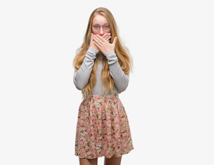 Sticker - Blonde teenager woman wearing flowers skirt shocked covering mouth with hands for mistake. Secret concept.