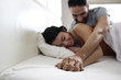 © Diego Cervo - Happy Latino Couple Holding Hands In Home Bed