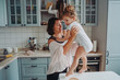 © teksomolika - Happy family having fun in the kitchen