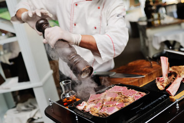 the chef holds a master class for cooking meat for the guests of the restaurant