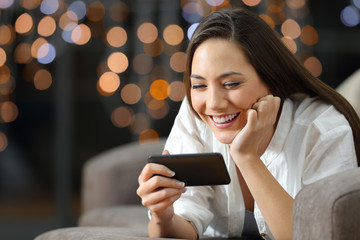 Poster - Girl watching media content in a phone in the night