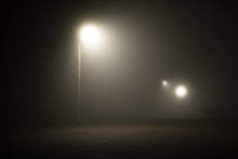 Street Lights Foggy Misty Night Lamp Post Lanterns Deserted Road. Lonely Street At Night In The Light Of Lanterns. Foggy Night Parking Lot