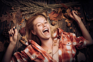 Wall Mural - Sweet young woman playing with leaves and looks very sensually. Fashion portrait of beautiful Surprised woman. Attractive young woman wearing in fashionable seasonal clothes having Autumnal mood.